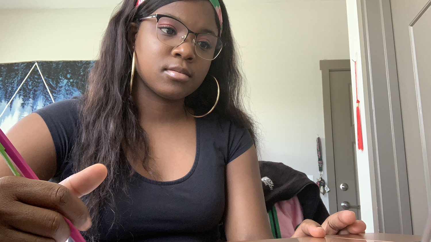 Student Mariah Wilder works on schoolwork at her home desk.