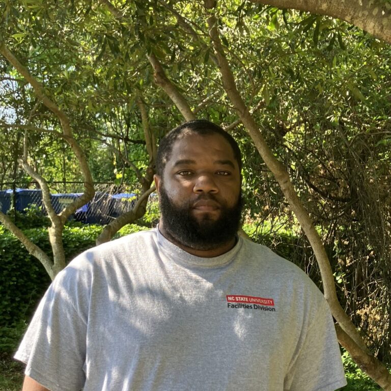 Charles Ormond Headshot WRR Staff Standing Outside Under Green Tree